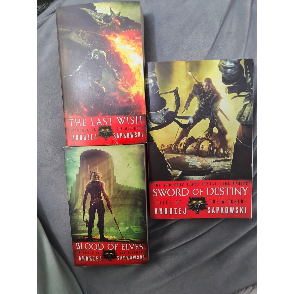 three paperbacks from The Witcher series by Andrzej Sapkowski